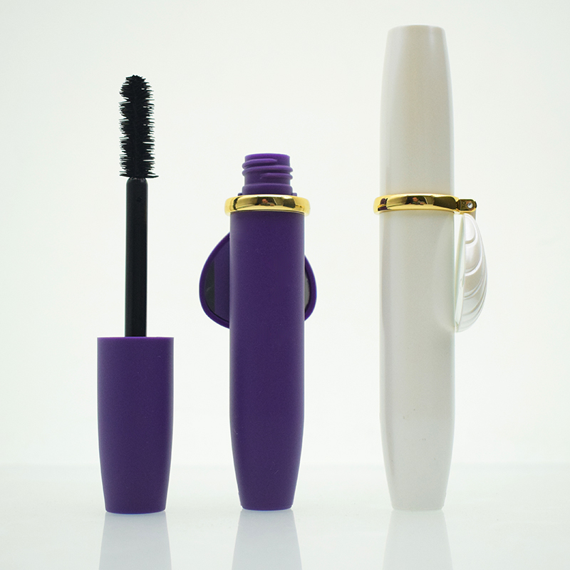 Purple and white mascara packaging with applicator brush